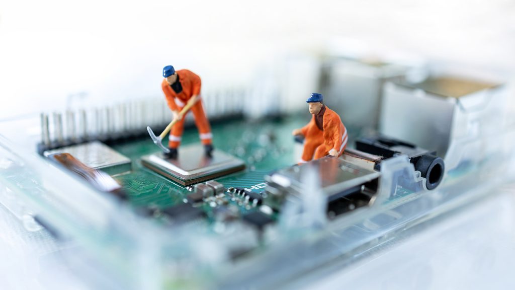 Miniature people searching or checking for bugs and issue on mic